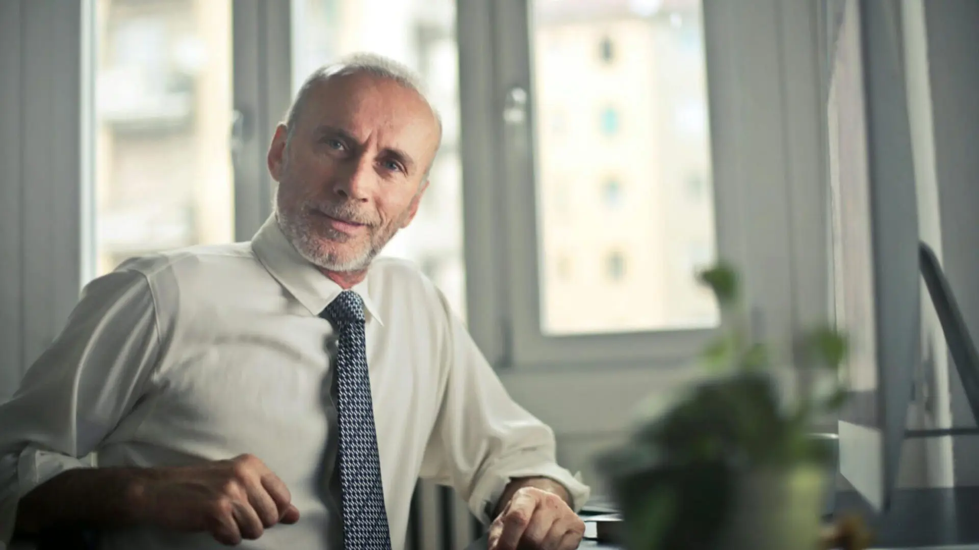 A man wearing a white shirt and a tie